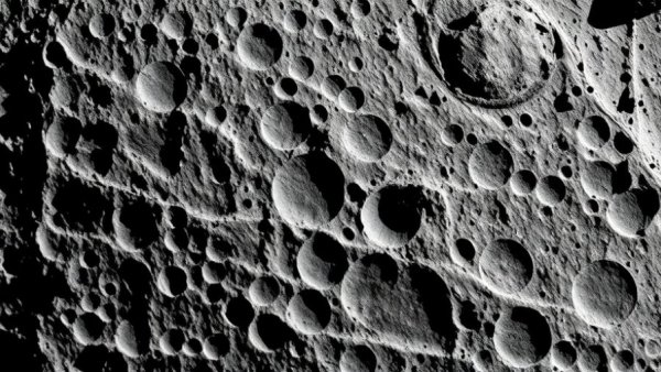 Detailed view of lunar surface craters in space.