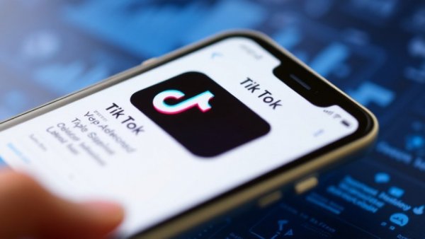 Smartphone showing TikTok app download page, focusing on business growth capital.