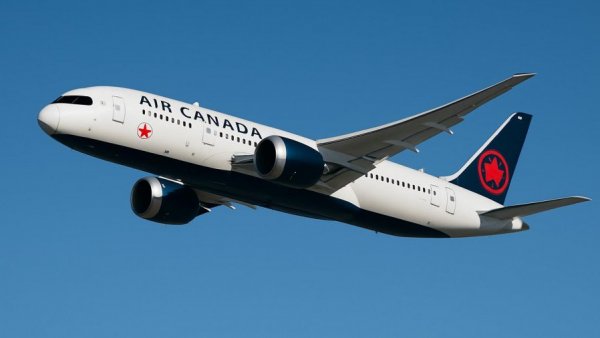 Air Canada plane flying in clear sky, Los Cabos travel destination