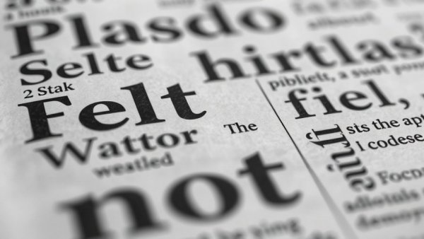 AI Inference and World Models depicted with random newspaper text in black and white.