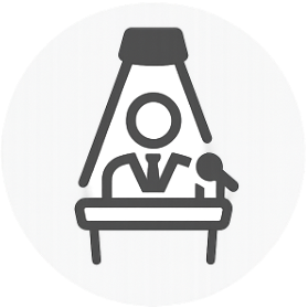 Icon of a person under spotlight at a podium with a microphone