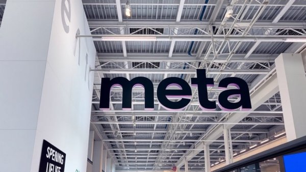 Meta logo displayed prominently in a modern exhibition hall.