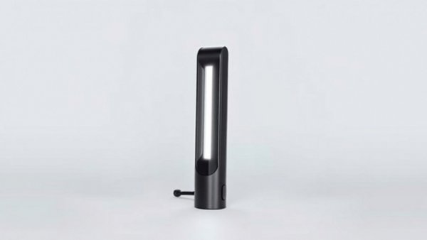 Sleek minimalist cordless lamp on white background.