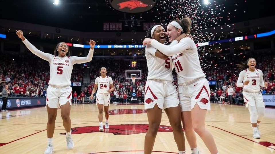 Arkansas Women's Basketball Coach giving a dynamic speech.