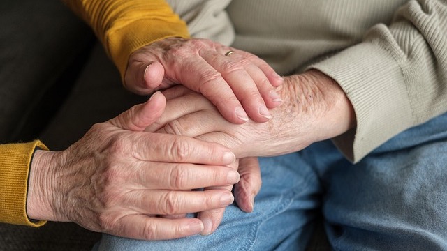 Close-up of hands holding gently, symbolizing Navigating Aging and Special Needs Care.