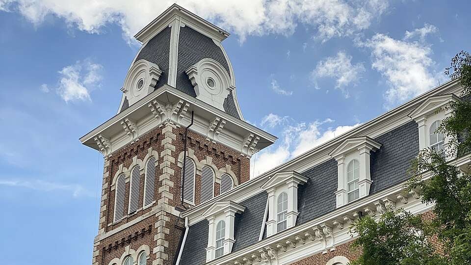 University of Arkansas student population reaches 34,000 depicted in a vibrant poster.