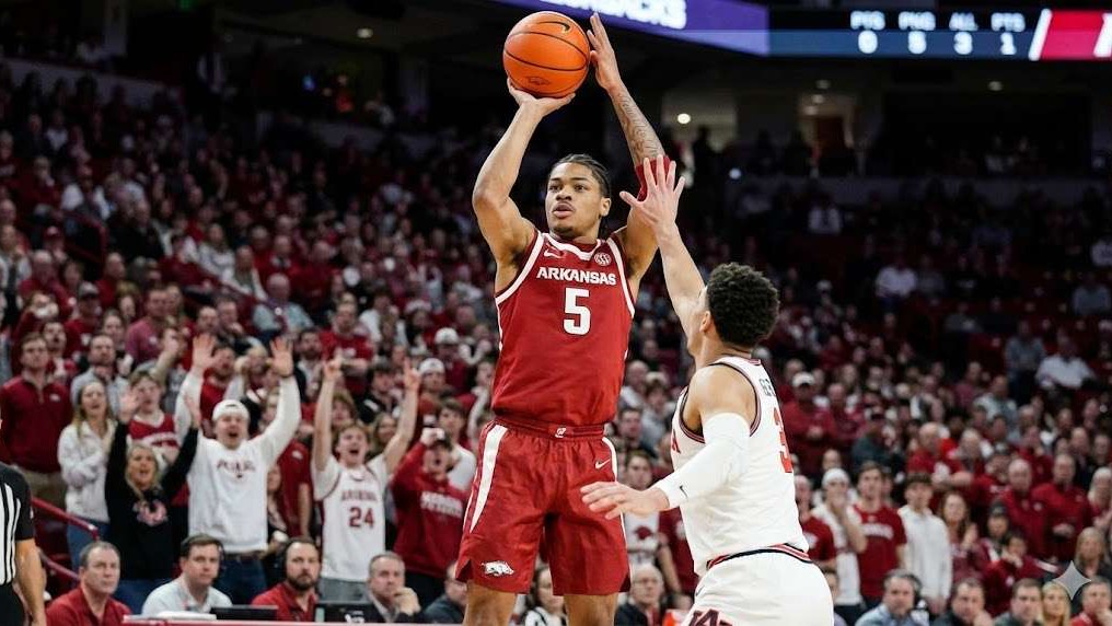 Arkansas basketball road loss at Georgia, player goes for layup, dynamic game scene.