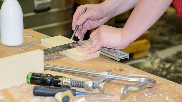 Support Local Single Parents Initiative workshop with participants holding handmade boards.
