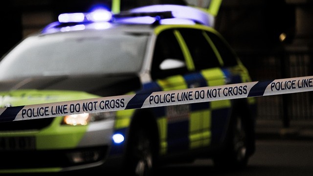 Portrait of a young man smiling indoors.