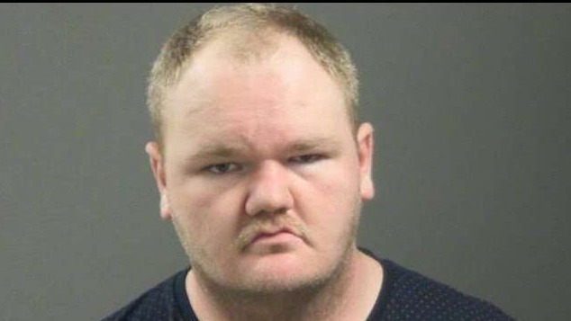 Blurred mugshot of an unidentified person with a serious expression.