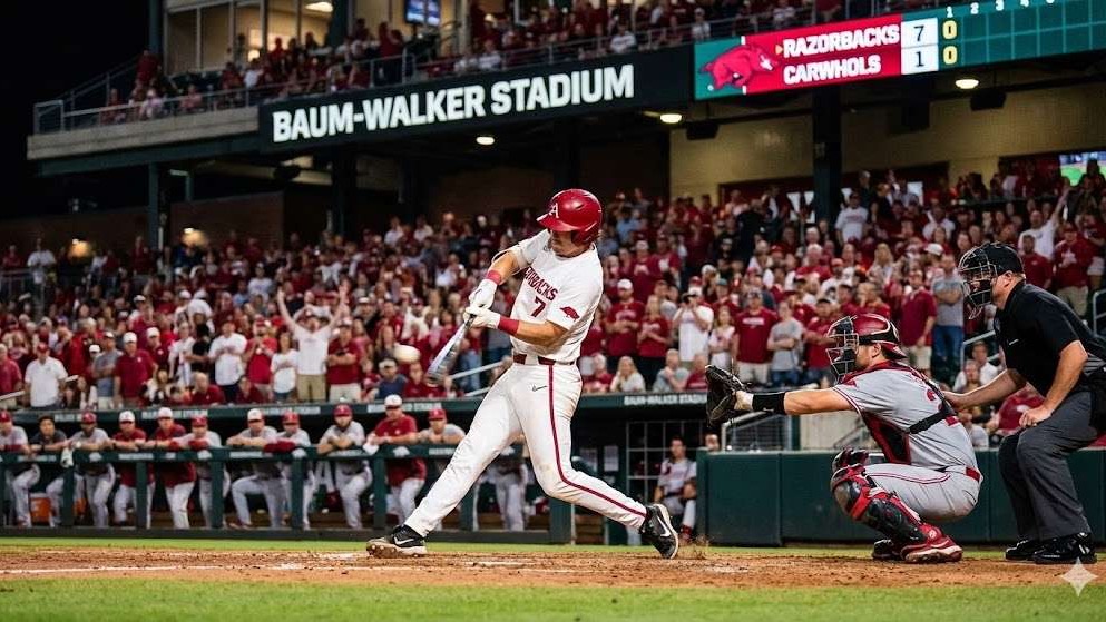 Arkansas Razorbacks Pitching Staff Roles: player mid-pitch with stadium backdrop.