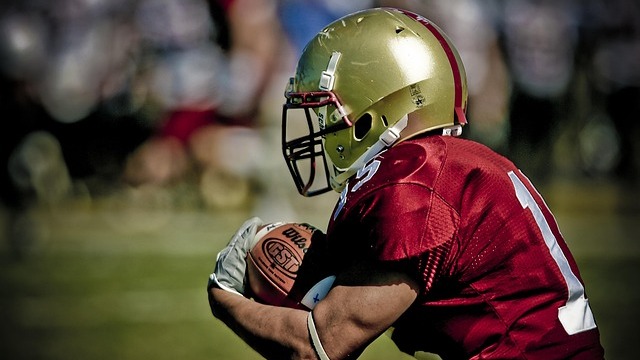 Dynamic future of Razorback football players in a bustling stadium.