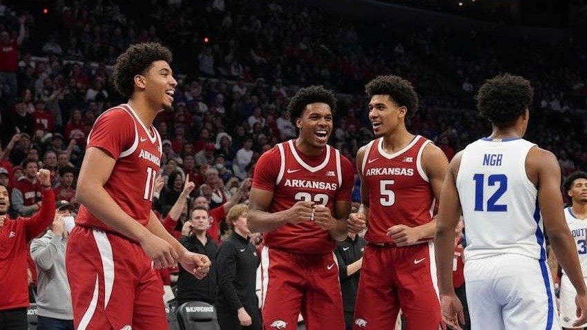 Arkansas Razorbacks basketball players at press conference.