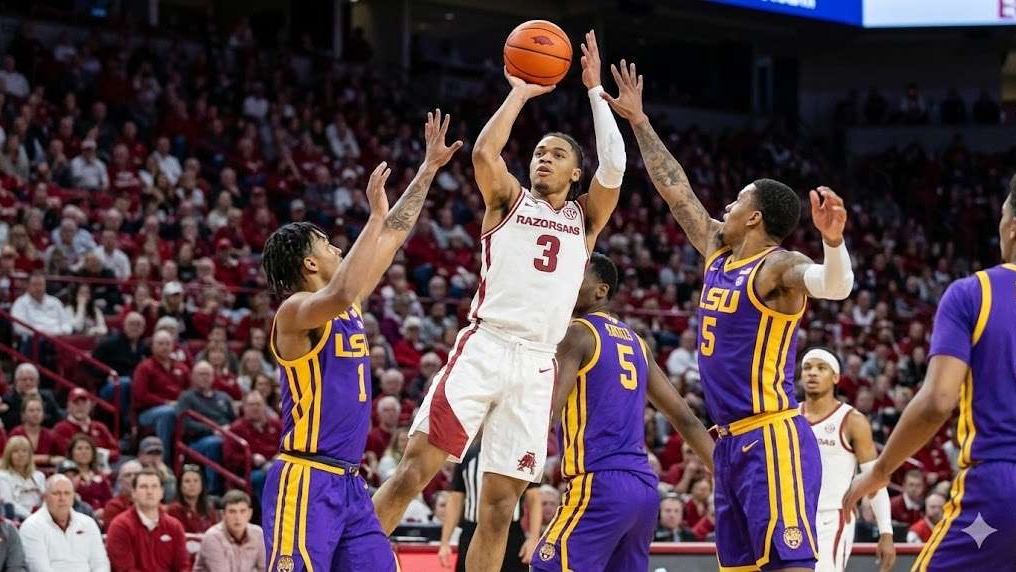 Arkansas Razorbacks player shoots over LSU defender, thrilling basketball action.