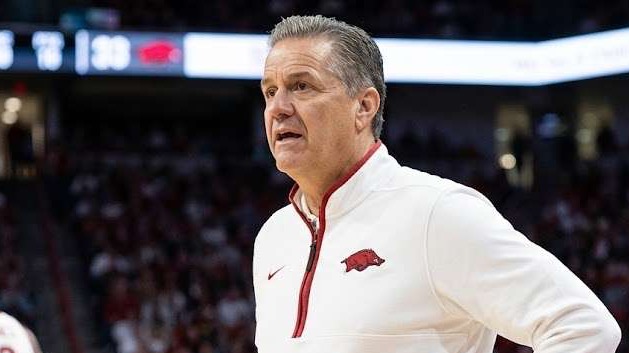 Arkansas Basketball Roster Decisions: Coach gestures energetically during a game.