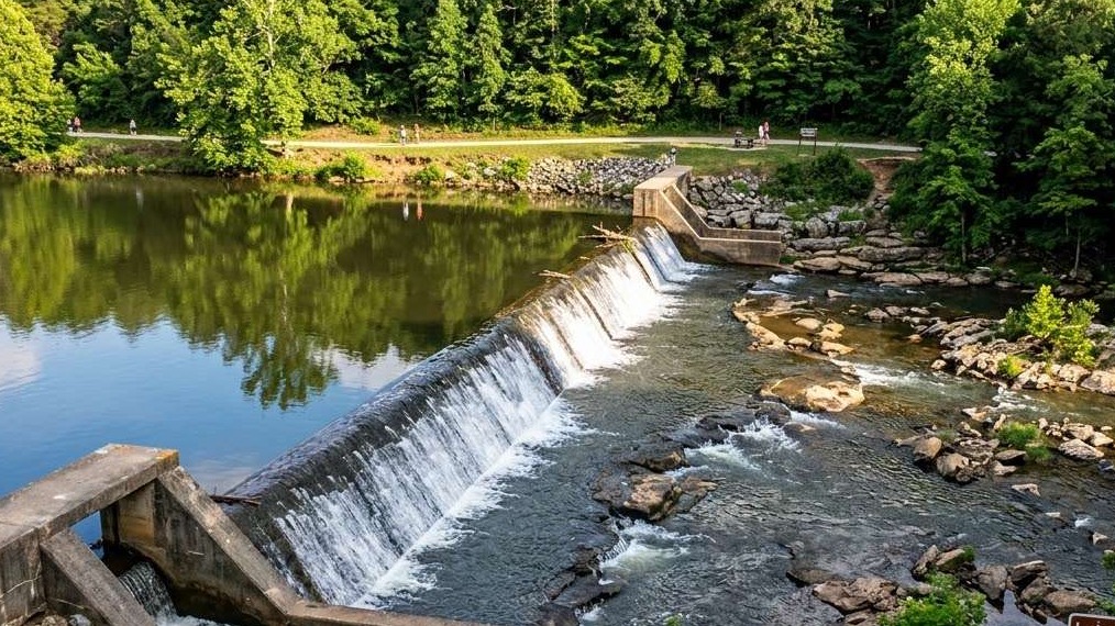 Little Sugar Dam renovation announcement with colorful geometric design.