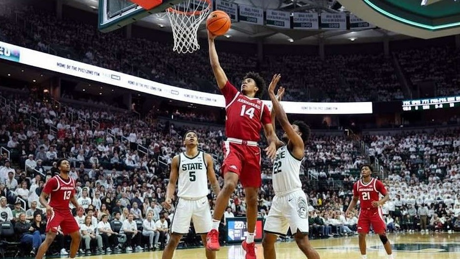 Arkansas basketball players celebrating performance on court.
