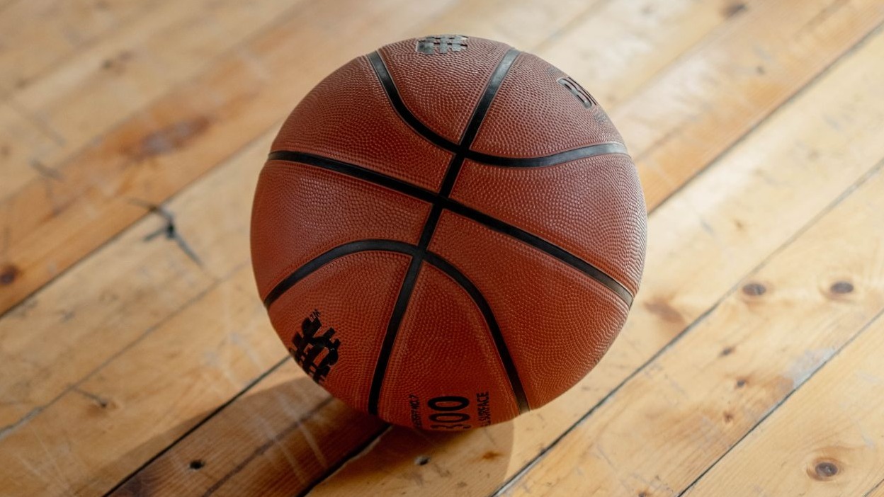 Caleb Holt visit announcement on podcast with basketball theme.