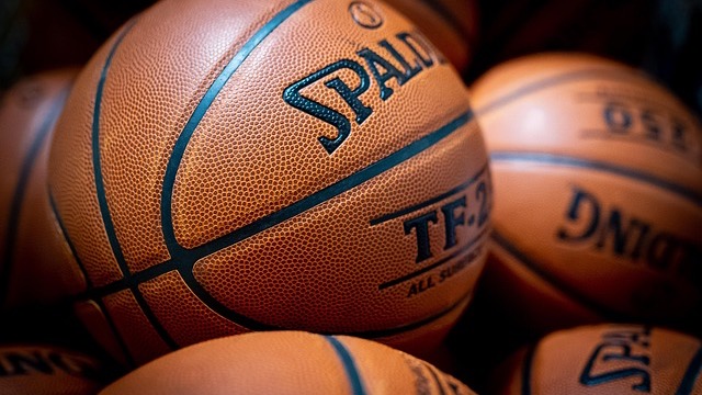 Abdou Toure visits Arkansas basketball, player in red jersey