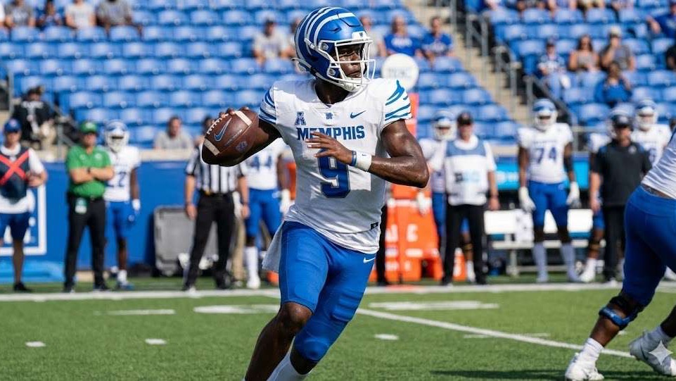 AJ Hill Transfers to Arkansas: Football player in action on field.