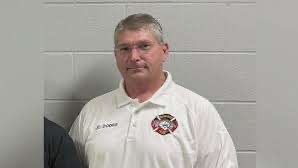 News anchor discussing FBI investigation into Prairie Grove Fire Chief resignation.