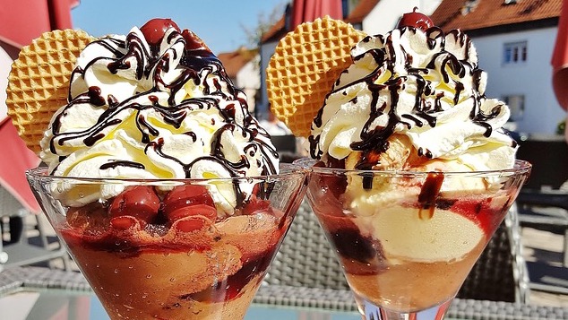 Two people with headphones at a bustling ice cream shop, Clementine’s Ice Cream.