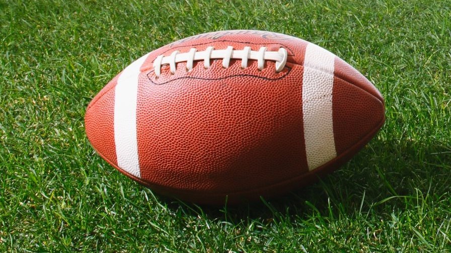 Arkansas football coach during practice indoors.
