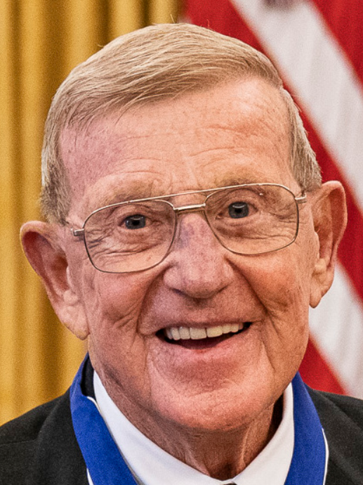 Lou Holtz Coaching Legacy: Elderly man at press conference.