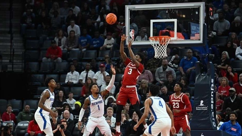 Energetic basketball player during SEC game prediction.