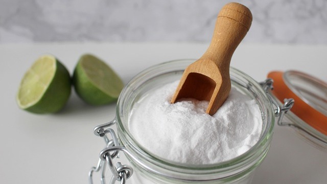 National Bicarbonate of Soda Day with a scoop of soda on blue.