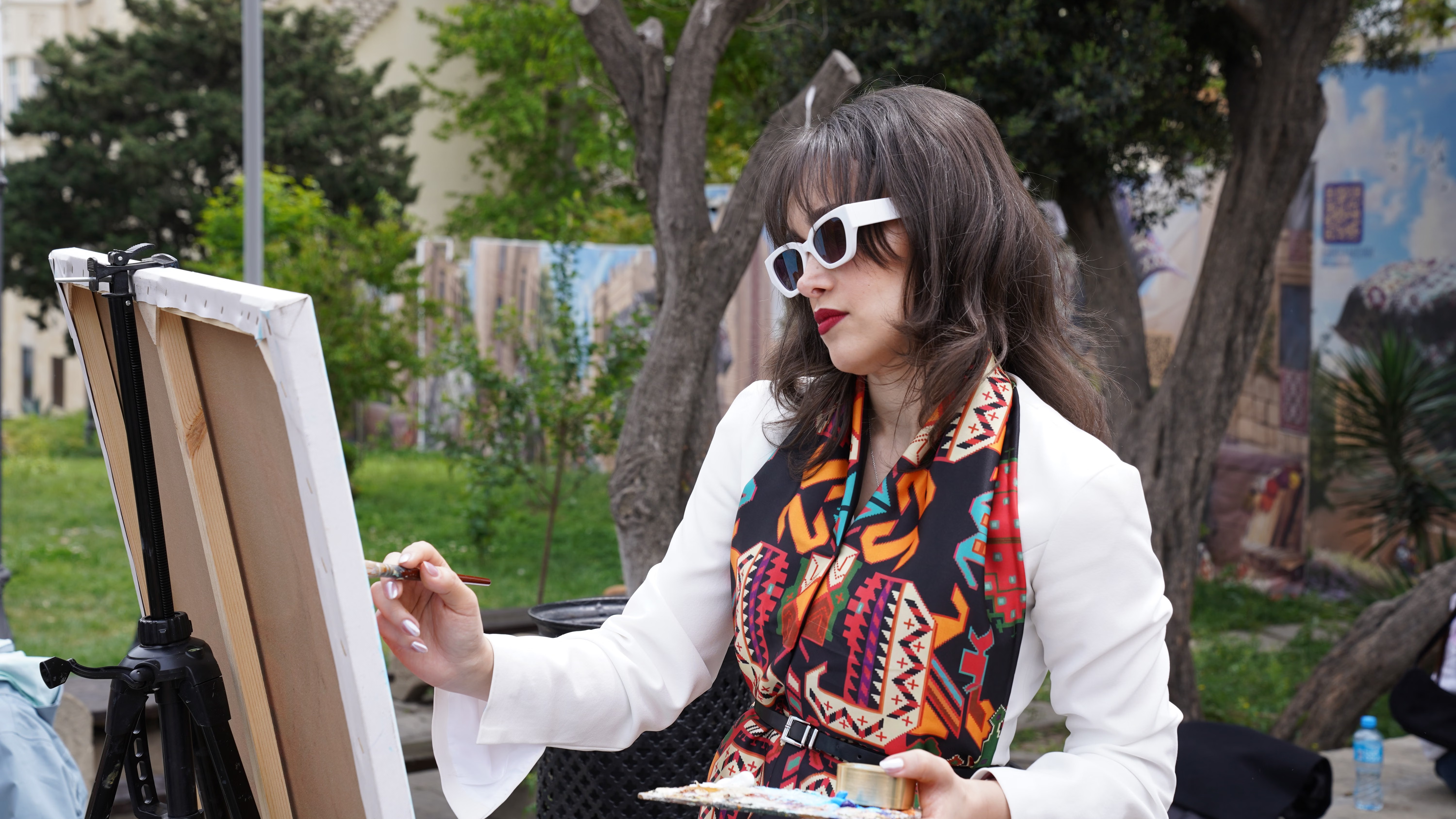Artist painting in Dave Peel Park pavilion, vibrant scene