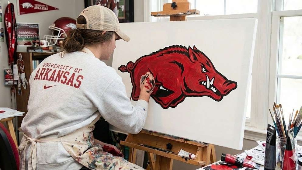 Smiling woman with Razorback art, Razorback Spirit Merchandise.