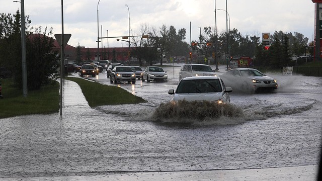 Bentonville flooding concerns; cars on submerged street.