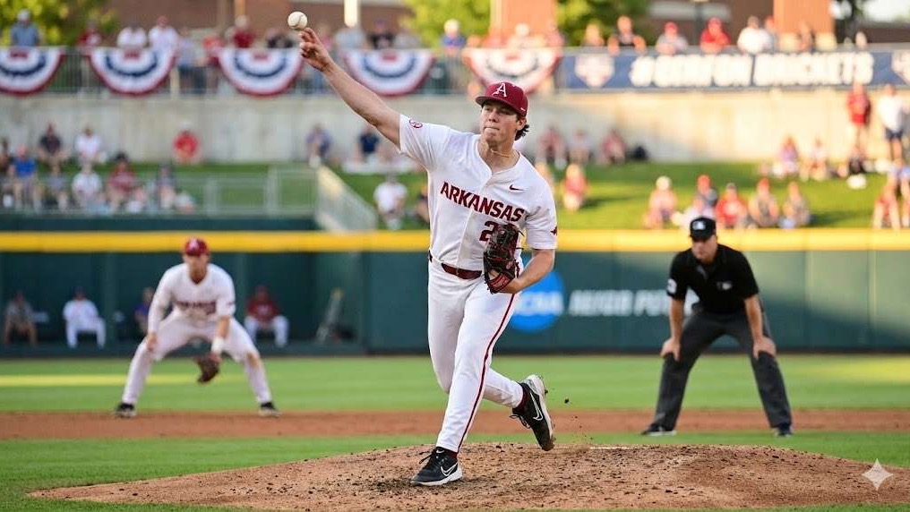 Hogs home opener win press conference with coach in red attire.