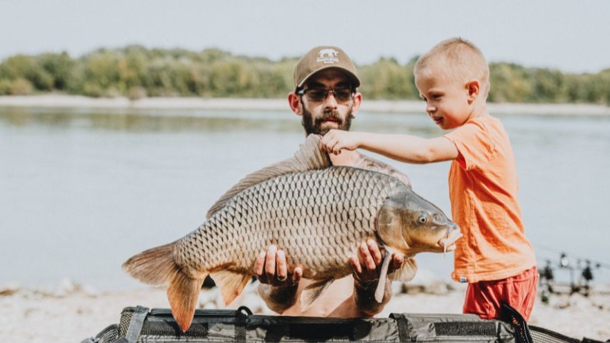 Father and son fishing adventure in nature, catch of the day.