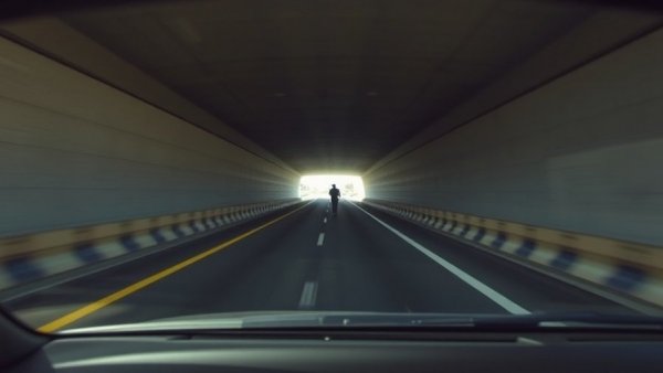 Police use of force captured on dashcam in urban tunnel setting.