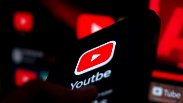 Close-up of YouTube app on smartphone screen displaying navigation options.