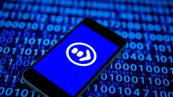 Close-up of smartphone with company logo over binary code, AI chip smuggling scandal