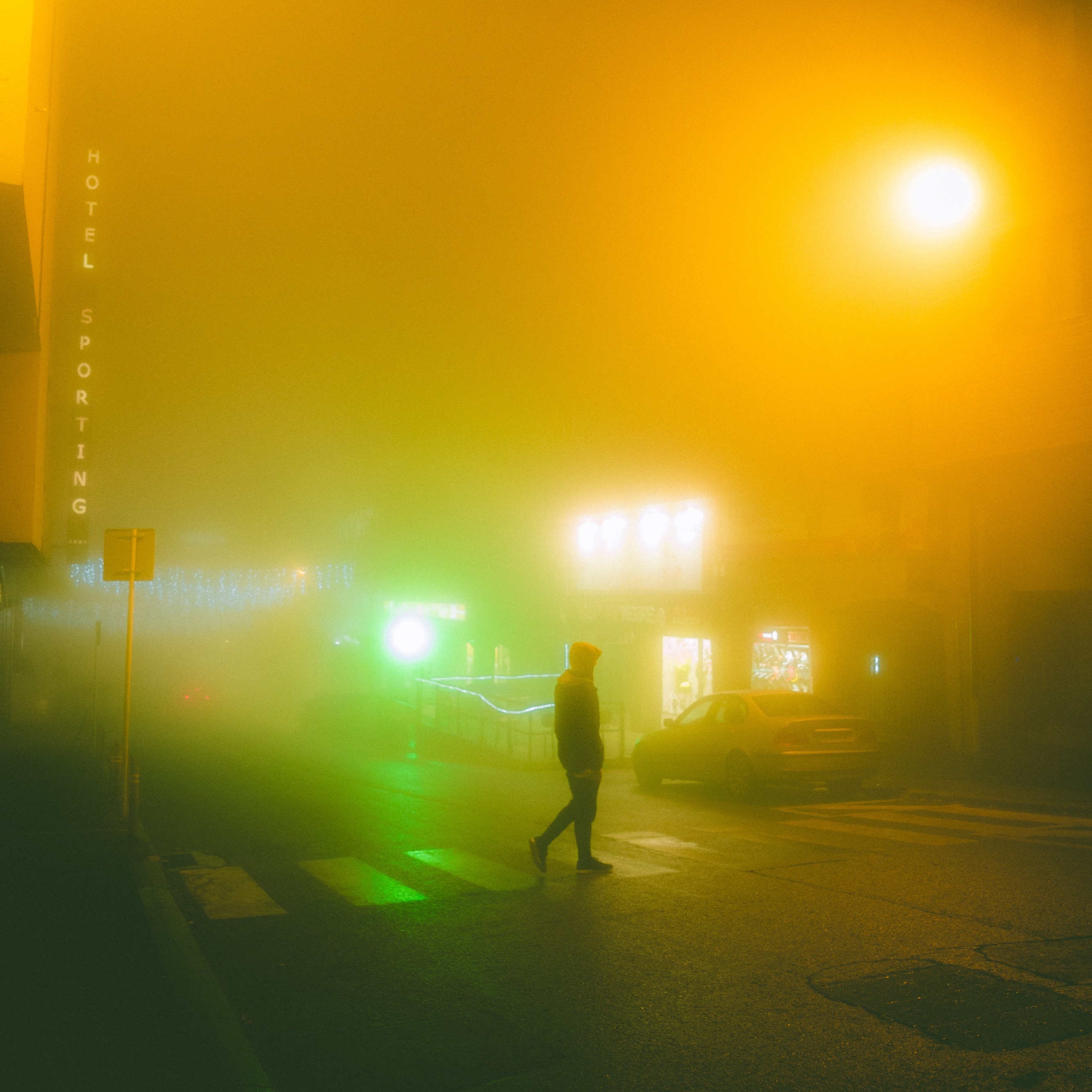 photo of pedestrian at crosswalk in fog