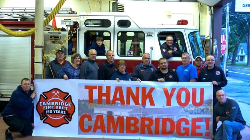 Fire Department Members with 'Thank You Cambridge' banner