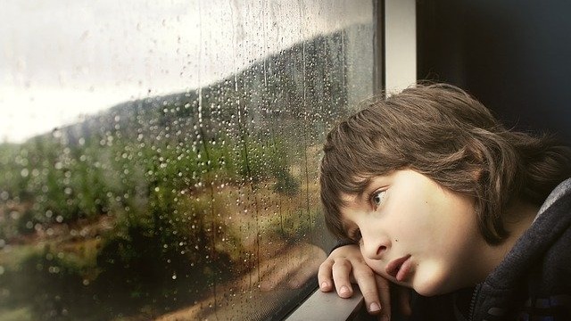 Boy staring out of train window