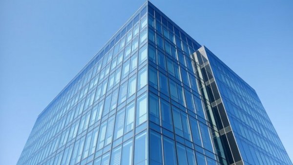 Modern glass building facade representing memory trade impact on import export manufacturers.