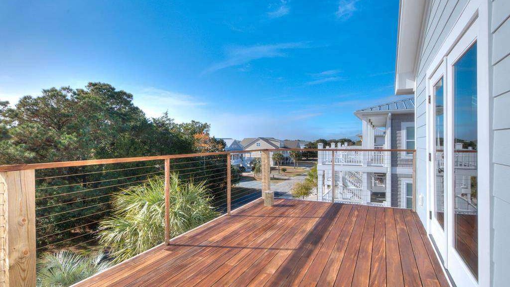breathtaking oceanfront sunset, awe-inspiring beauty, casting long shadows, photorealistic, panoramic view of the ocean meeting the horizon, highly detailed, vibrant clouds with pink and orange hues, ISO 100, soft twilight glow, low-light evening setting, shot with a 50mm prime lens.