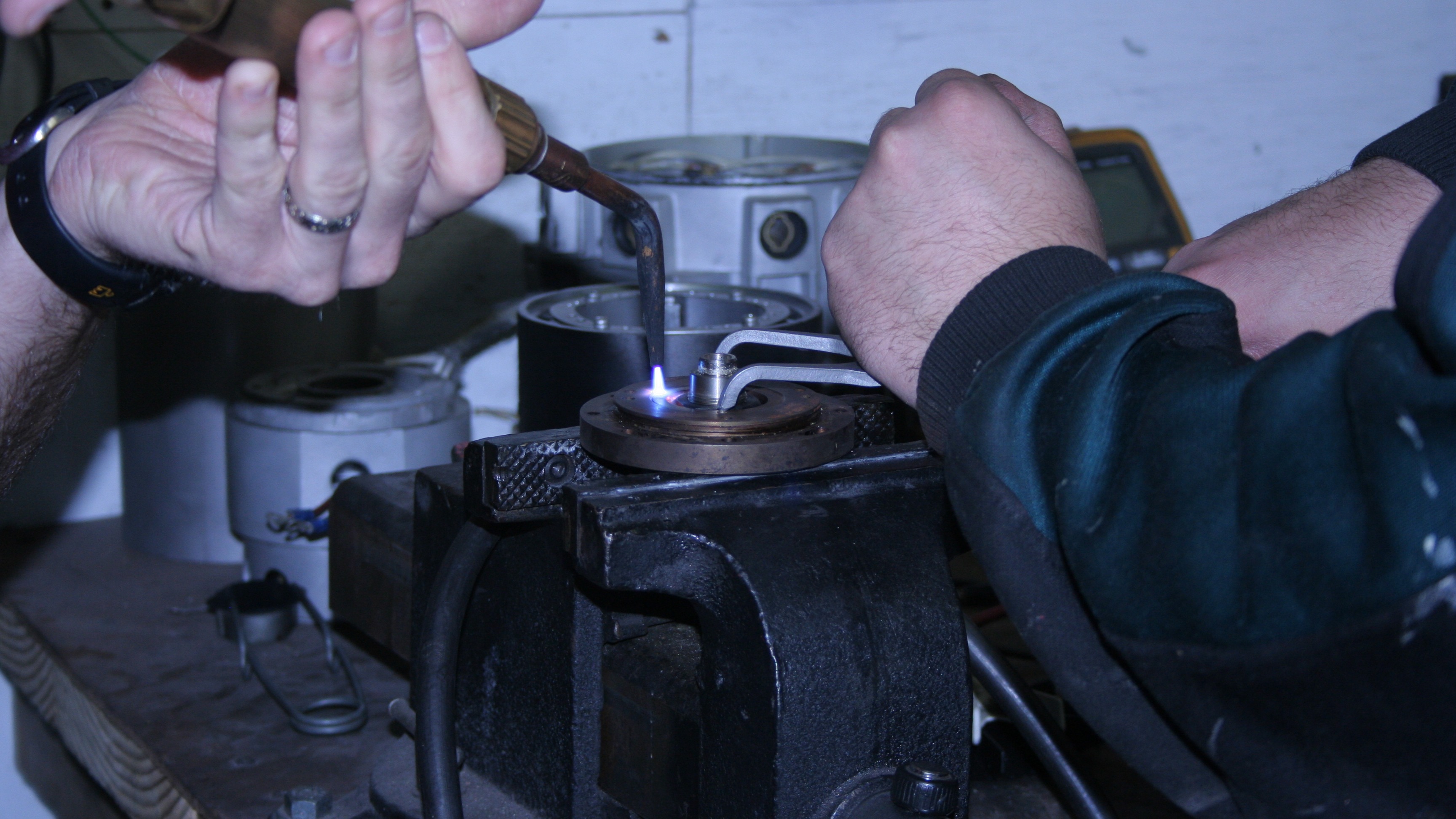 Skilled technician carefully repairing a servo motor in a modern electronics workshop, emphasizing precision in servo motor repairs.