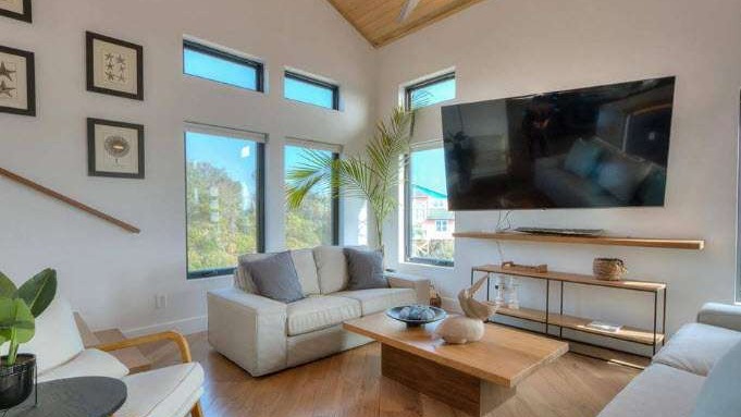 pristine Island Beach, relaxing expression, inviting sunbathers, photorealistic, turquoise waters meeting white sand, highly detailed, seagulls in flight, perfect symmetry, vibrant blues, bright sunlight, shot with a wide-angle lens.