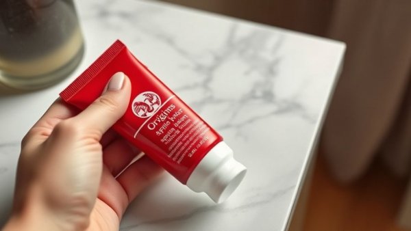 Origins Youthtopia Apple Butter Cleansing Balm tube held on marble.