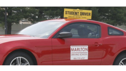 Experienced driver, concentrated expression, smoothly controlling a racing car, photorealistic, racetrack with cheering crowds, highly detailed, dynamic motion blur, ISO 100, metallic hues, overcast lighting, shot with a 200mm telephoto lens.