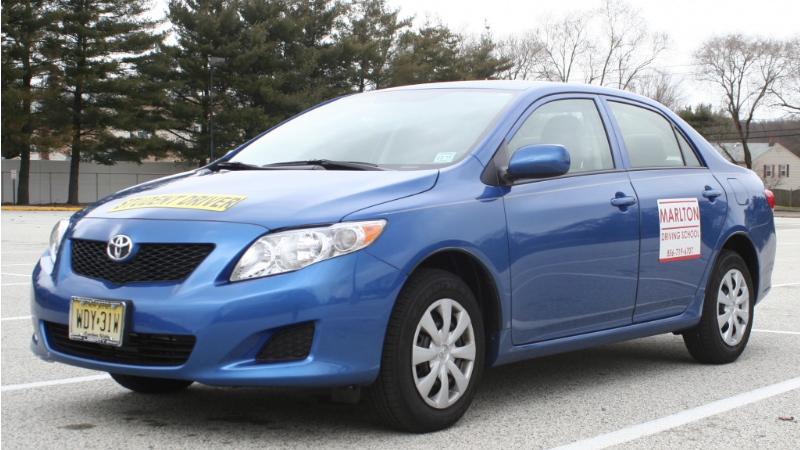 Masterful driver, composed expression, mastering a hairpin turn, photorealistic, coastal road with ocean view, highly detailed, sea spray in the air, f/3.5 aperture, pastel colors, sunrise lighting, shot with a 24-70mm lens.