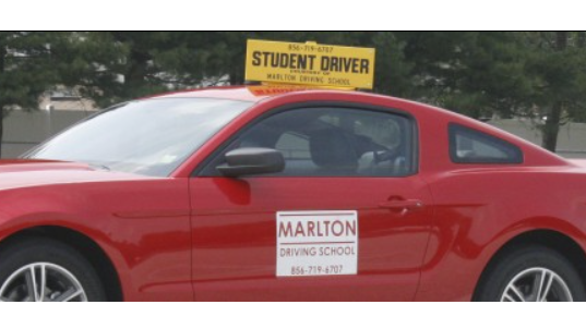 Gifted driver, thoughtful expression, maintaining perfect speed, photorealistic, serene countryside road with rolling hills, highly detailed, wind-blown leaves, ISO 50, green hues, overcast lighting, shot with a 105mm lens.