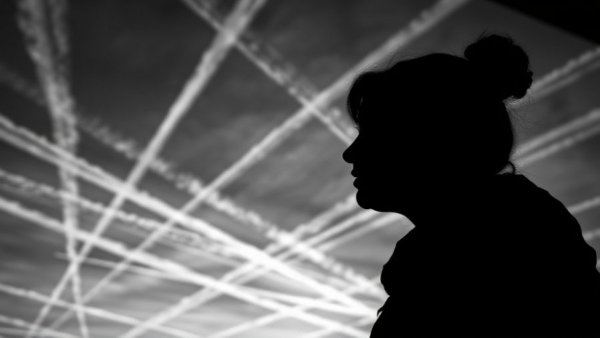 Silhouette woman with chemtrails, illustrating why laws banning chemtrails are not working.